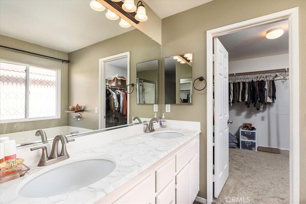 42064 Pine Needle Street Temecula, CA 92591 - Photo 17 of 39 a bathroom with a sink and a mirror