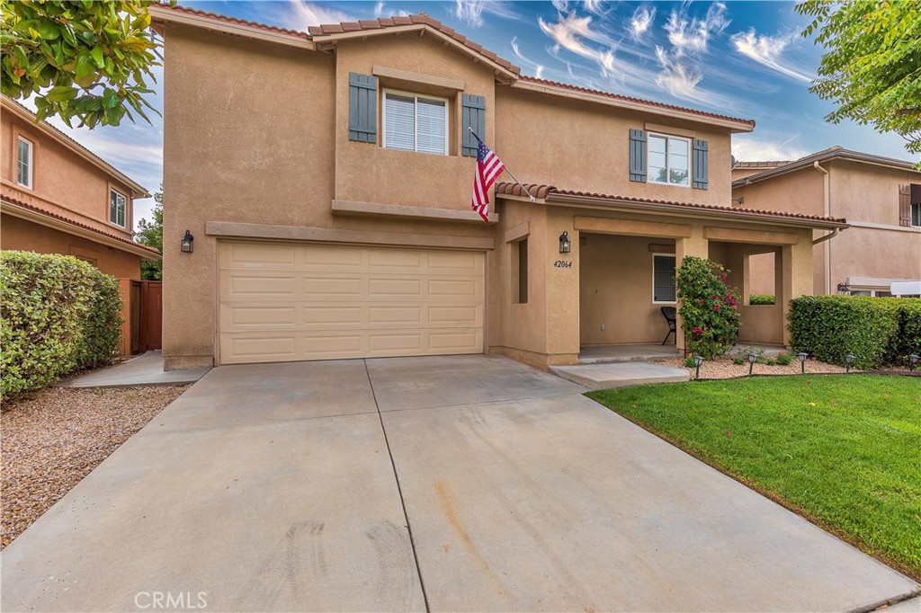 42064 Pine Needle Street Temecula, CA 92591 - Photo 3 of 39 a front view of a house with a yard and garage