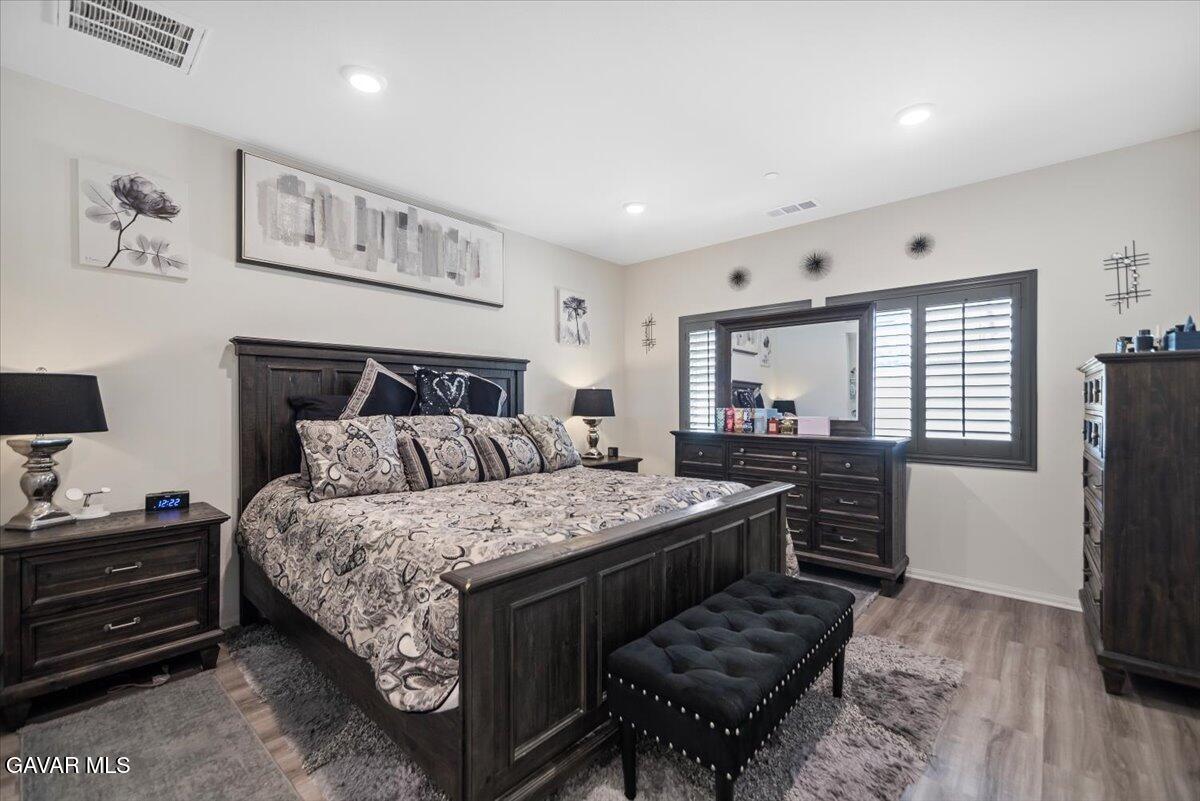 44304 43rd Street West Lancaster, CA 93536 - Photo 16 of 37 a bedroom with a bed and a dresser in it