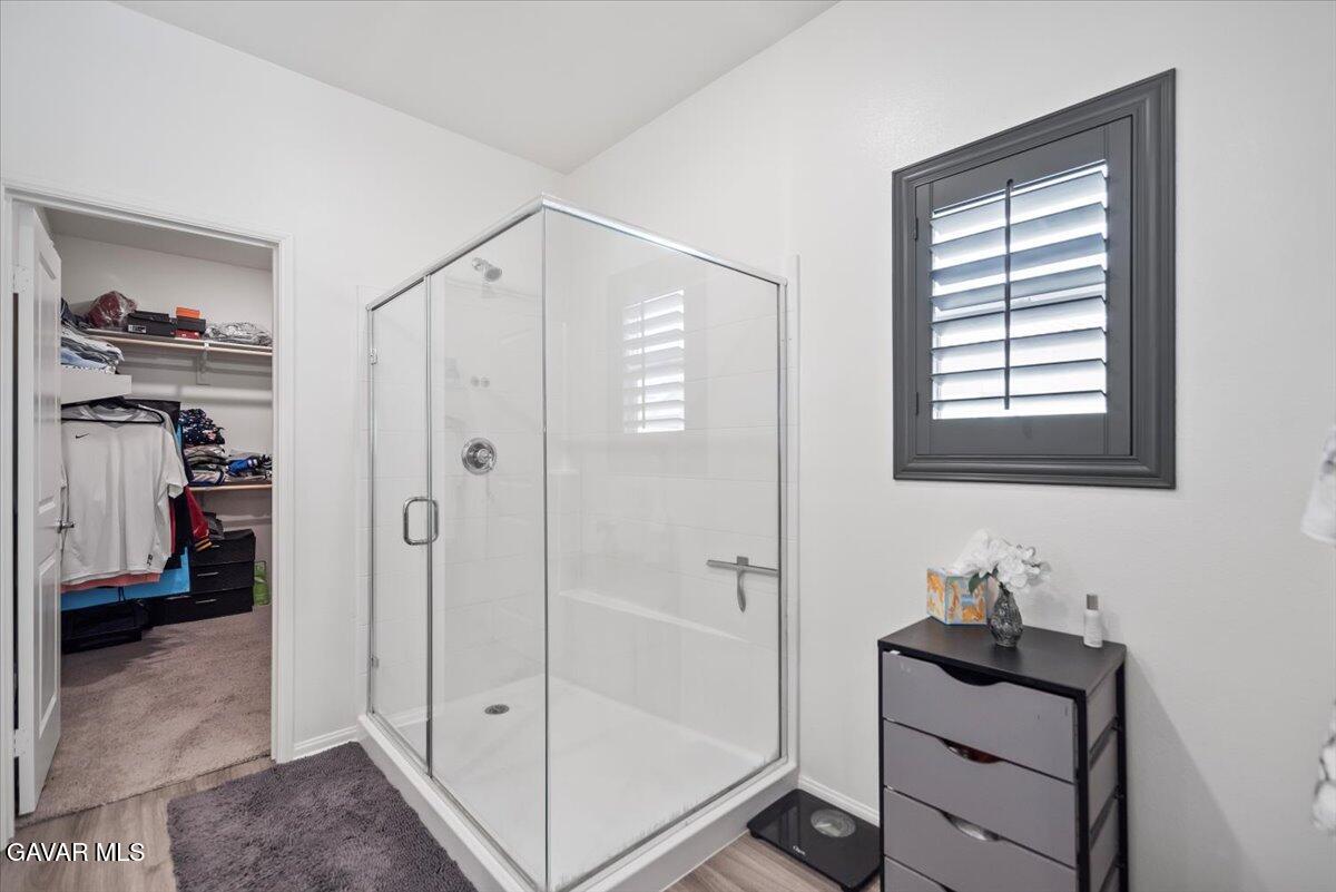 44304 43rd Street West Lancaster, CA 93536 - Photo 18 of 37 a bathroom with a shower a sink and a window