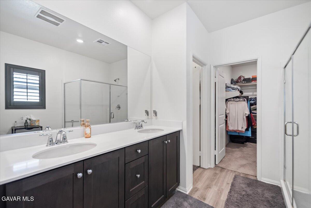 44304 43rd Street West Lancaster, CA 93536 - Photo 19 of 37 a en suite bathroom with a sink double vanity and a mirror