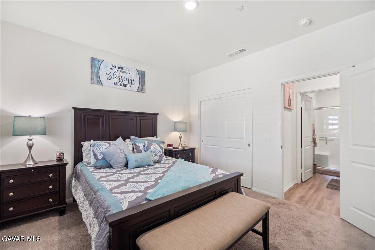 44304 43rd Street West Lancaster, CA 93536 - Photo 20 of 37 a bedroom with a bed and a dresser in it