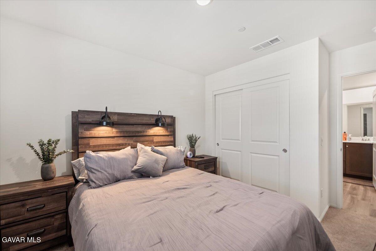 44304 43rd Street West Lancaster, CA 93536 - Photo 25 of 37 a bedroom with a bed and wooden floor