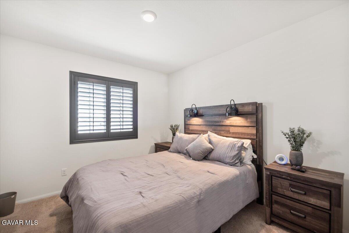 44304 43rd Street West Lancaster, CA 93536 - Photo 26 of 37 a bedroom with a bed and a potted plant