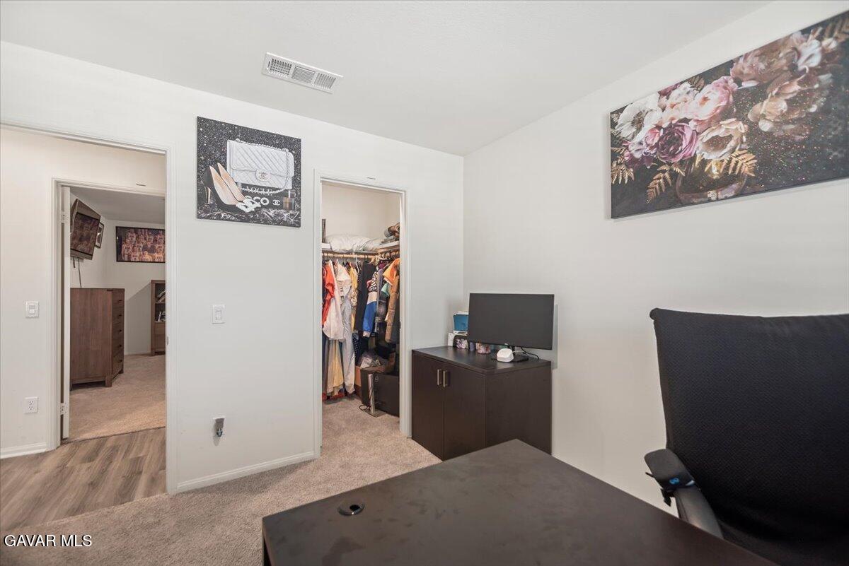 44304 43rd Street West Lancaster, CA 93536 - Photo 28 of 37 a workspace with furniture and lamp