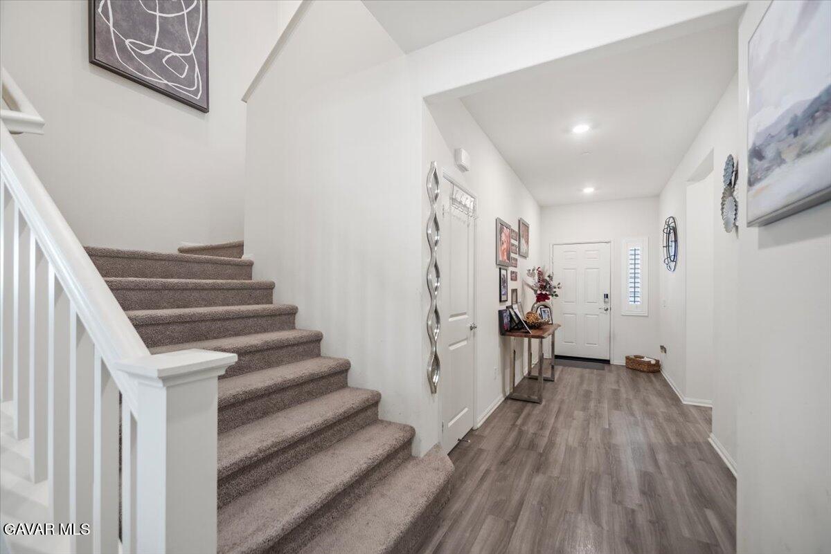 44304 43rd Street West Lancaster, CA 93536 - Photo 4 of 37 a view of a hallway with wooden floor and stairs