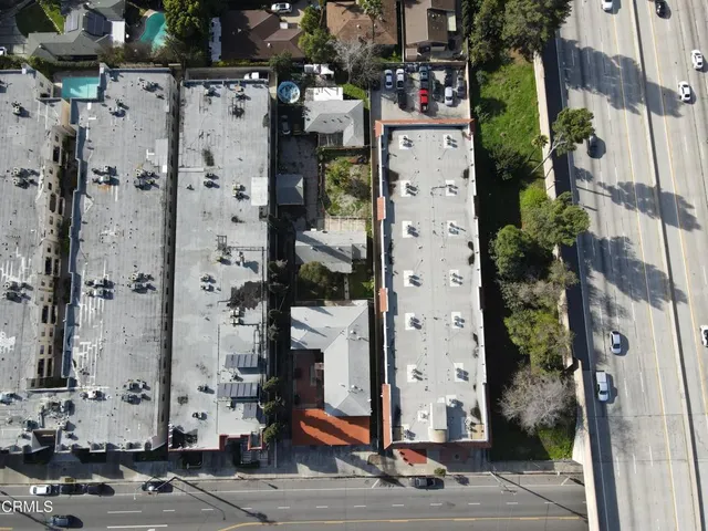 a aerial view of multi story residential apartment building with yard