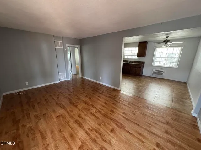 a kitchen with granite countertop a sink cabinets and stainless steel appliances