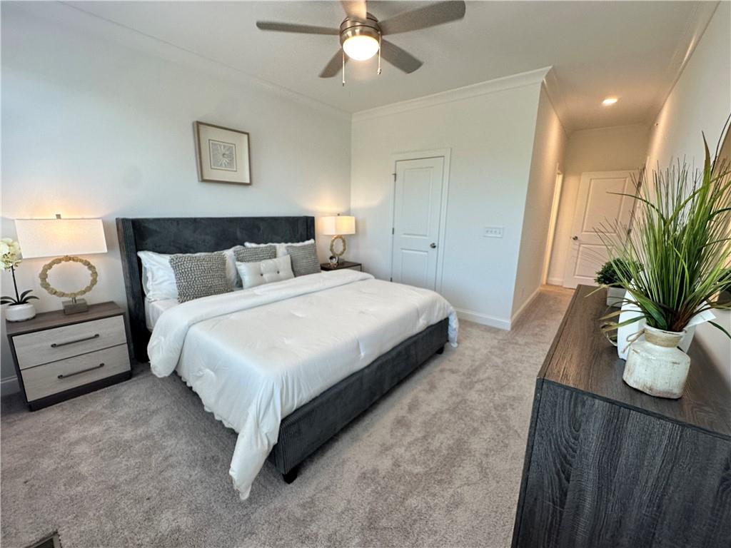 506 Alice Way, Unit D19 Cumming, GA 30040 - Photo 22 of 56 a bedroom with a bed and a potted plant