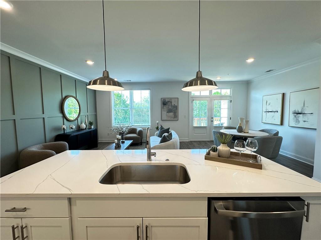 506 Alice Way, Unit D19 Cumming, GA 30040 - Photo 8 of 56 a kitchen with a sink a counter space appliances and cabinets