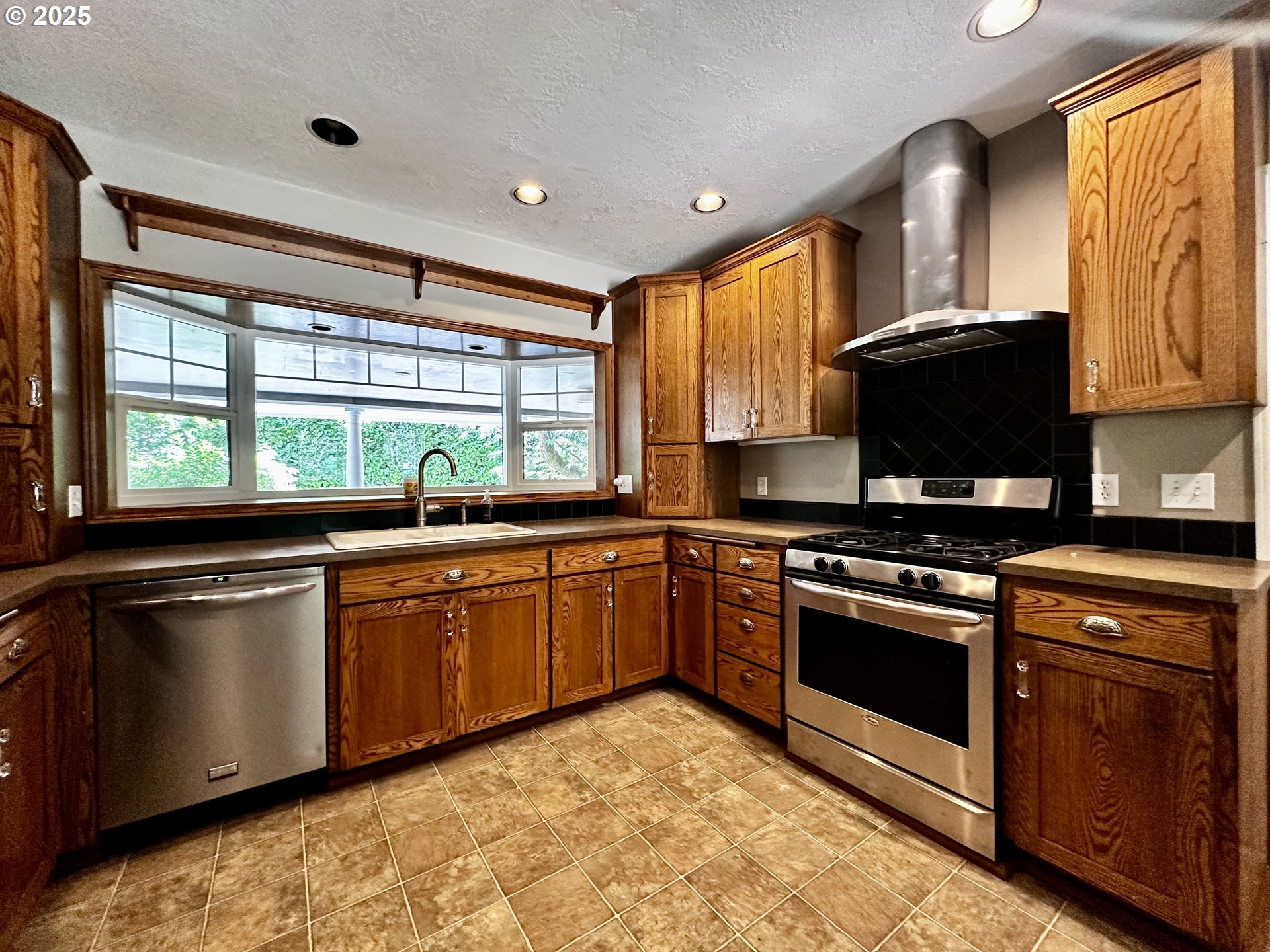 2453 Highway 20 Albany, OR 97321 - Photo 13 of 47 a kitchen with stainless steel appliances granite countertop a stove a sink and a microwave