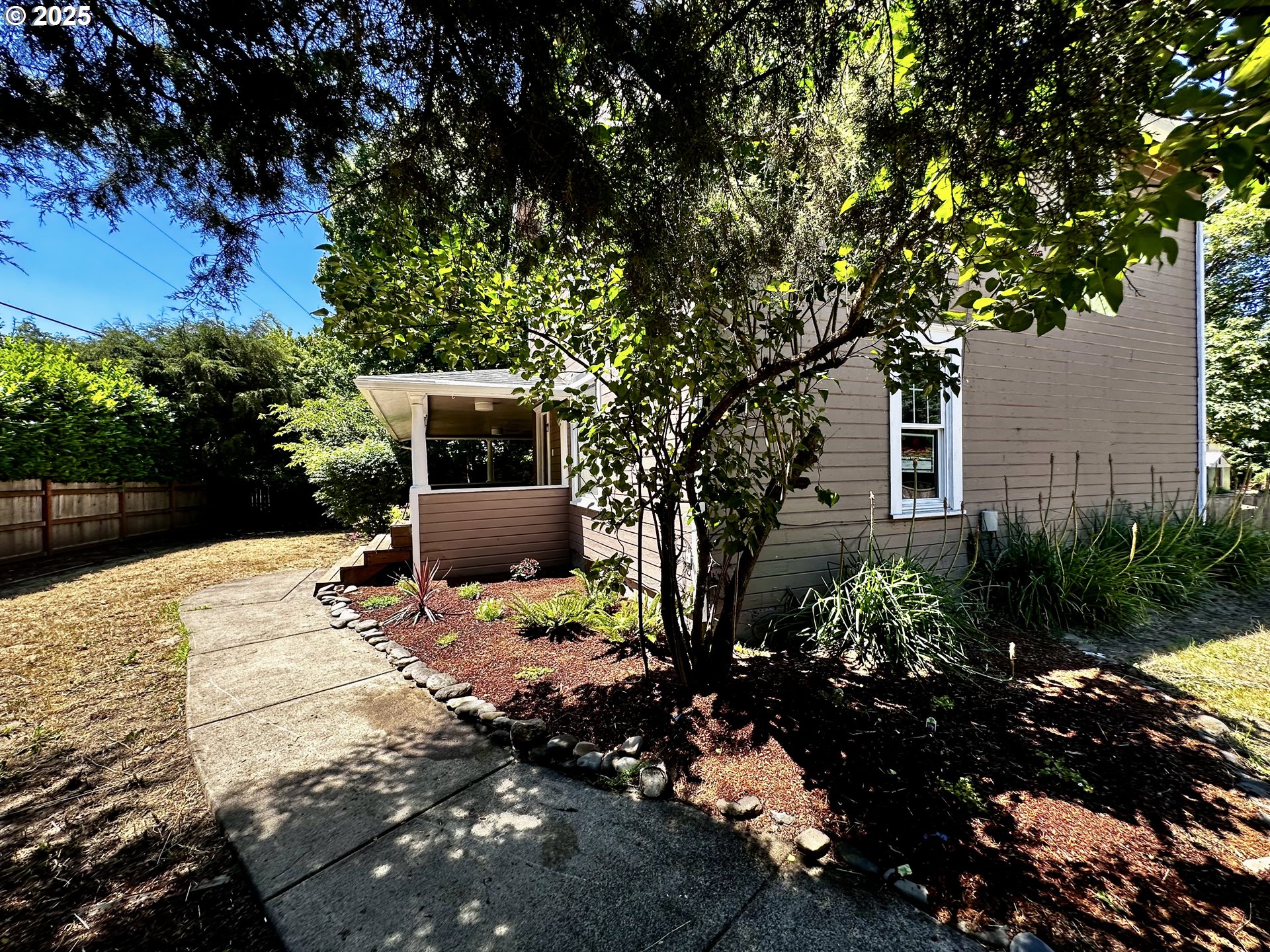 2453 Highway 20 Albany, OR 97321 - Photo 3 of 47 a backyard of a house with table and chairs under an umbrella
