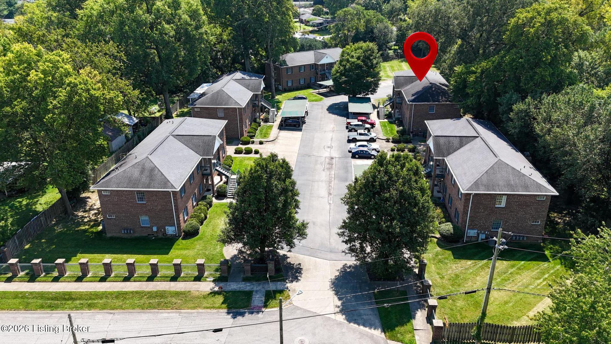 3112 Hendon Road Louisville, KY 40220 - Photo 1 of 26 Welcome to 3112 Hendon Road, a second-floor home among the trees! This aerial view showcases the condominium community’s wooded setting and abundant green space.