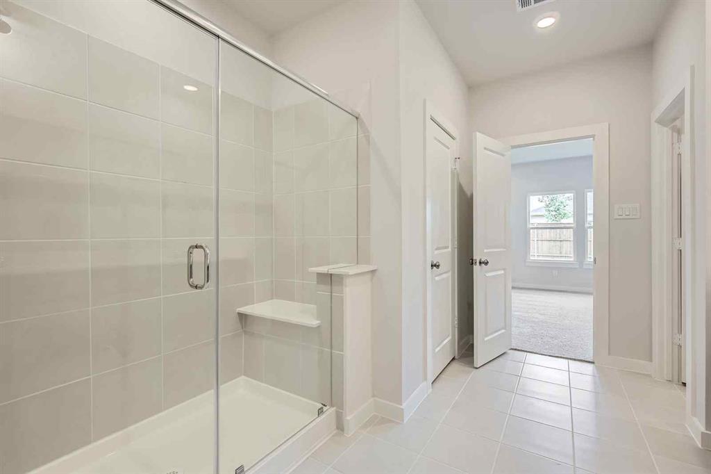 694 Cari Lane Forney, TX 75126 - Photo 14 of 40 a bathroom with a shower and a glass door