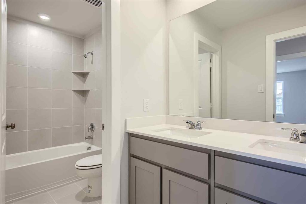 694 Cari Lane Forney, TX 75126 - Photo 18 of 40 a bathroom with a sink a toilet and shower