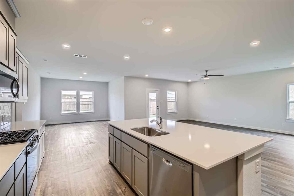 694 Cari Lane Forney, TX 75126 - Photo 7 of 40 a bathroom with a sink a large mirror and vanity