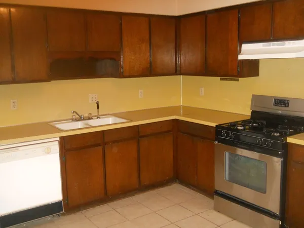 a kitchen with a sink stove and cabinets
