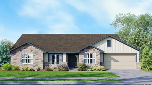 a front view of a house with a yard and trees