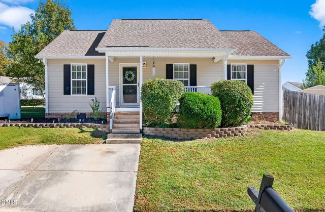 a front view of house with yard and green space