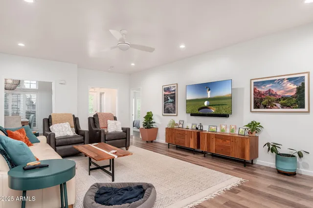 a kitchen with stainless steel appliances a sink a stove a refrigerator cabinets and a dining table