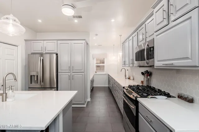 a large bedroom with a large bed and a dresser