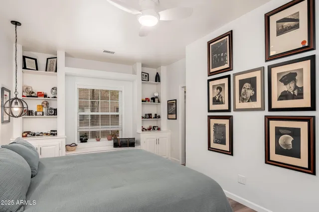 a view of a chair and table in the back yard of the house