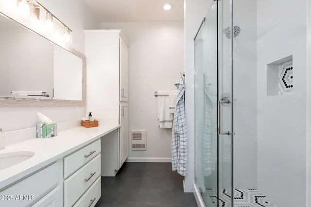 an aerial view of residential houses with outdoor space and trees