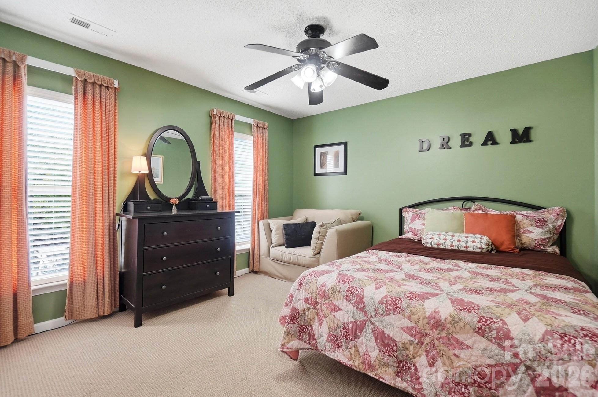 442 Sugar Maple Drive Tega Cay, SC 29708 - Photo 23 of 48 a bedroom with a bed and a chandelier