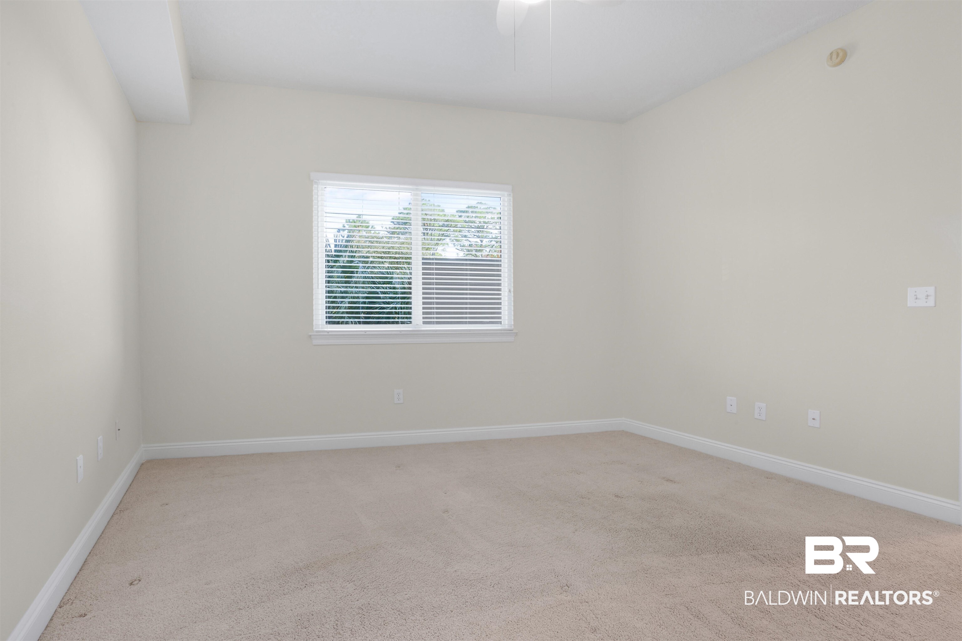 28250 Canal Road, Unit 106 Orange Beach, AL 36561 - Photo 25 of 50 Spare room featuring light carpet and baseboards