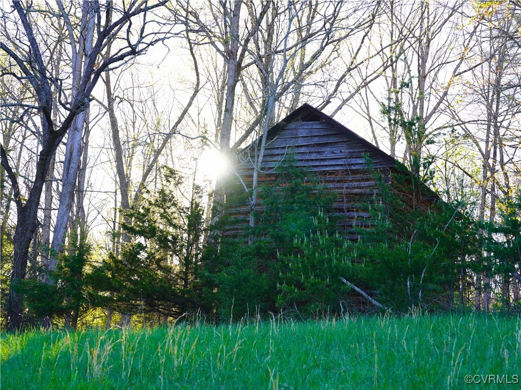 2632 Paisley Road Gretna, VA 24557 - Photo 46 of 49 a backyard of a house with lots of green space and plants