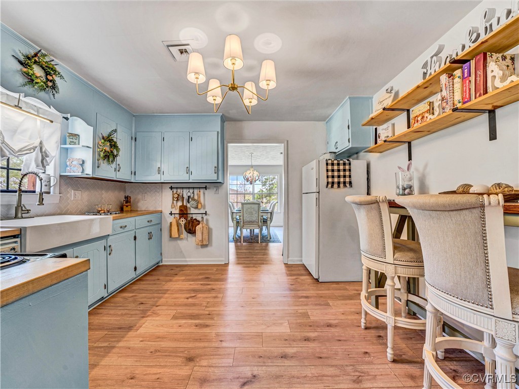 2632 Paisley Road Gretna, VA 24557 - Photo 6 of 49 a open kitchen with stainless steel appliances granite countertop a refrigerator oven stove a dining table and chairs with wooden floor