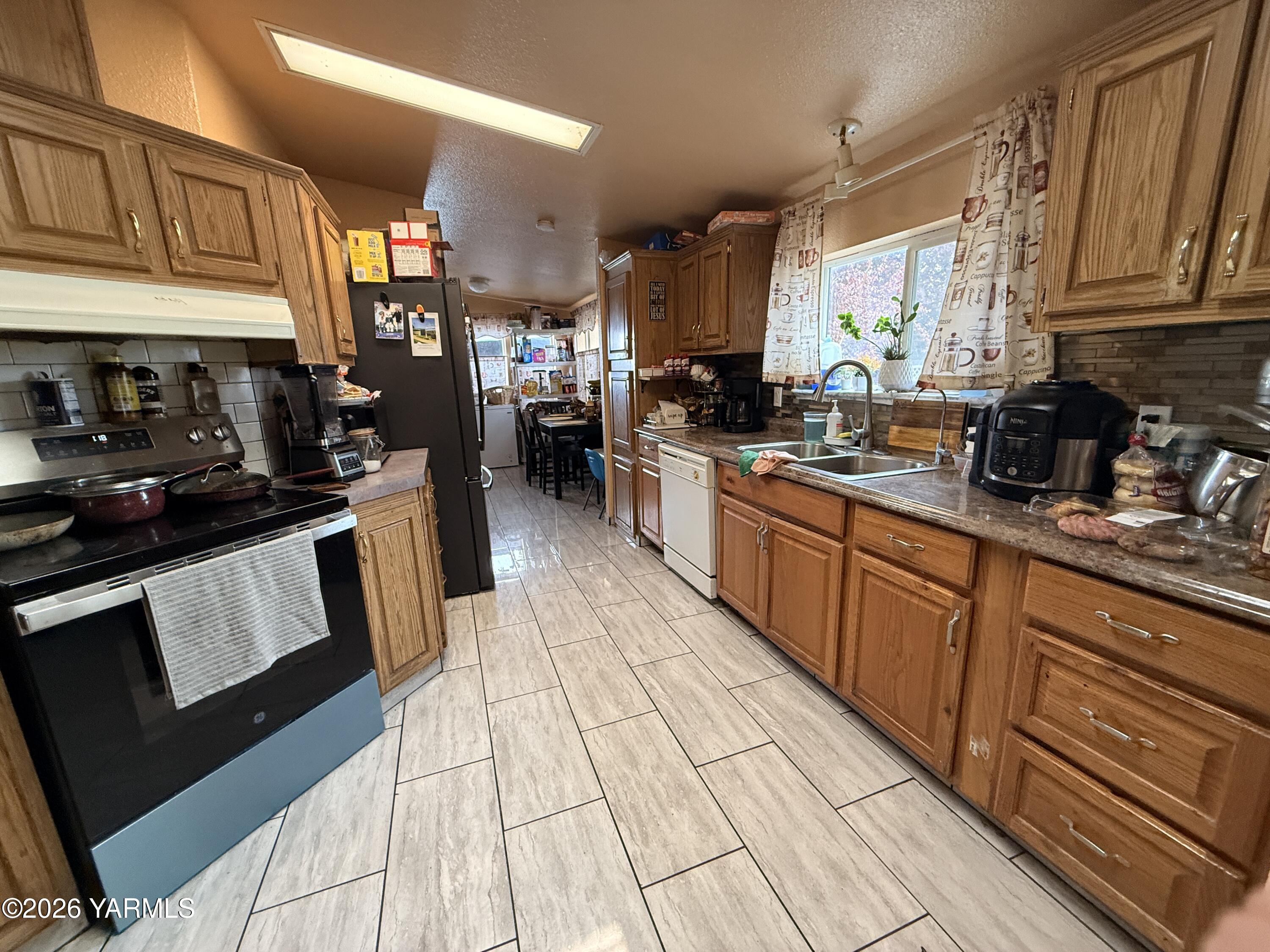 1051 County Line Mabton, WA 98935 - Photo 9 of 22 a kitchen with stainless steel appliances granite countertop a sink stove and cabinets