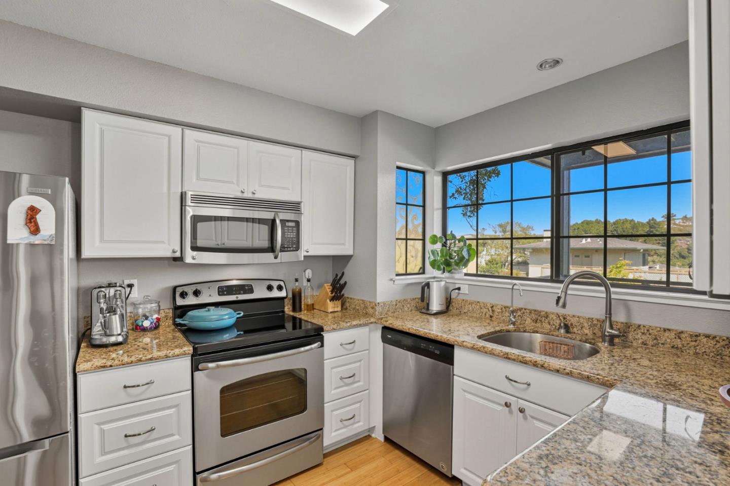 a kitchen with stainless steel appliances a stove sink and cabinets