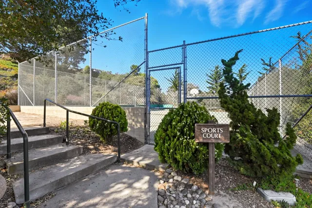 a street sign on a sidewalk next to a road