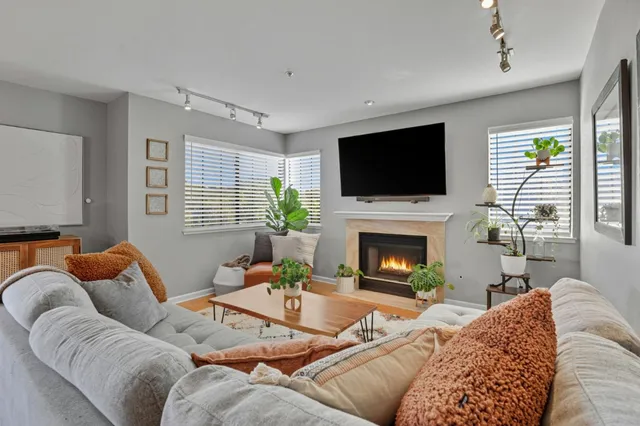 a living room with furniture a fireplace and a flat screen tv