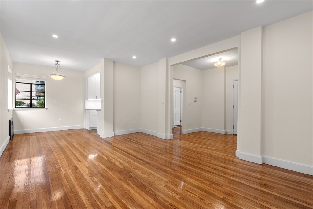 97 Strathmore Road, Unit 1 Boston, MA 02135 - Photo 2 of 16 a view of an empty room and wooden floor