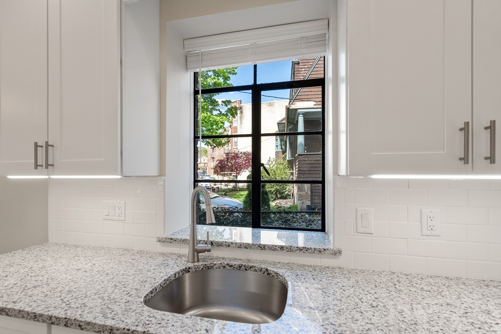 97 Strathmore Road, Unit 1 Boston, MA 02135 - Photo 7 of 16 a kitchen with a sink and a window