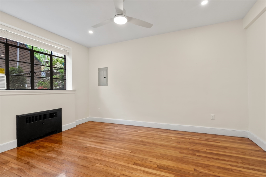 97 Strathmore Road, Unit 1 Boston, MA 02135 - Photo 9 of 16 a view of empty room with wooden floor and fan