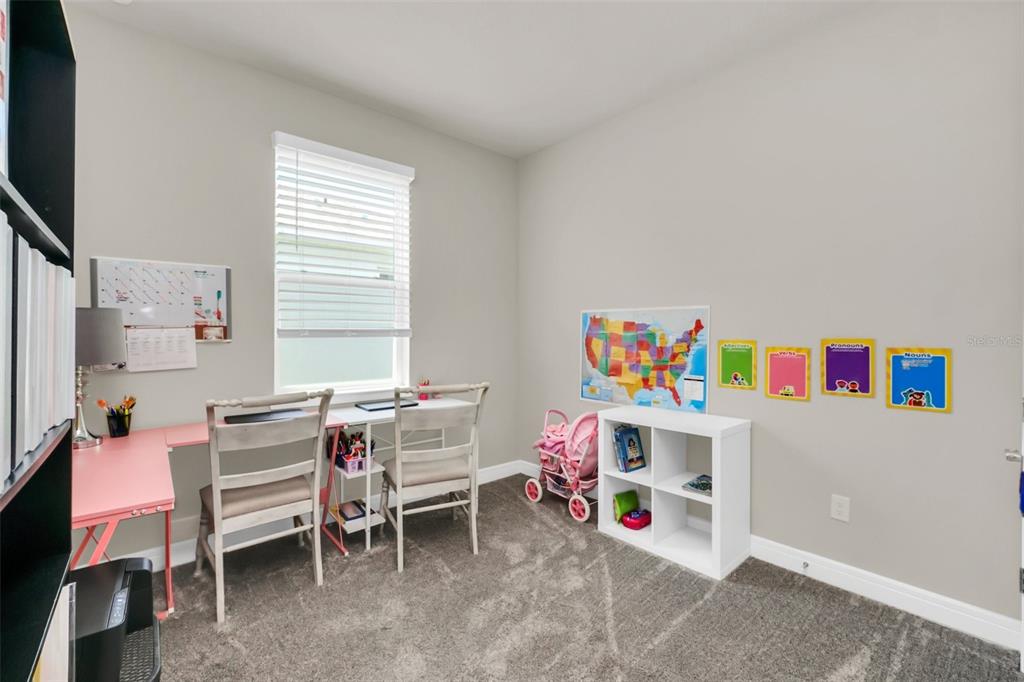 2001 Spring Shower Circle Kissimmee, FL 34744 - Photo 20 of 25 a room with furniture a baby crib and a table