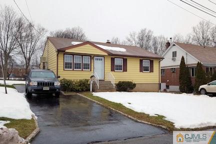 10 Maple Road Iselin, NJ 08830 - Photo 2 of 15 a view of a house with a yard covered in snow
