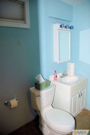 10 Maple Road Iselin, NJ 08830 - Photo 14 of 15 a white toilet sitting next to a bathroom sink