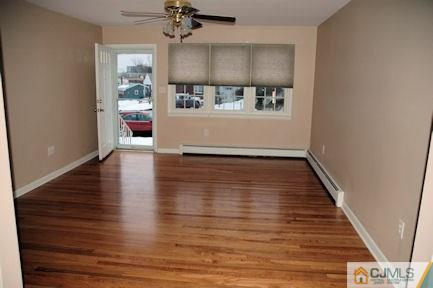 10 Maple Road Iselin, NJ 08830 - Photo 3 of 15 a view of a hallway with wooden floor and a living room