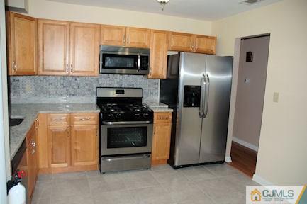 10 Maple Road Iselin, NJ 08830 - Photo 5 of 15 a kitchen with stainless steel appliances granite countertop a refrigerator stove and microwave