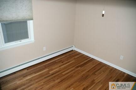 10 Maple Road Iselin, NJ 08830 - Photo 7 of 15 a view of room with wooden floor and fan