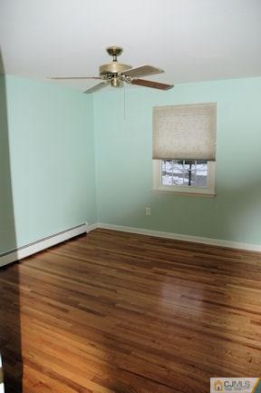 10 Maple Road Iselin, NJ 08830 - Photo 8 of 15 a view of a room with wooden floor and cabinet
