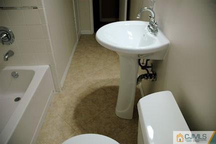 10 Maple Road Iselin, NJ 08830 - Photo 10 of 15 a bathroom with a sink toilet and shower