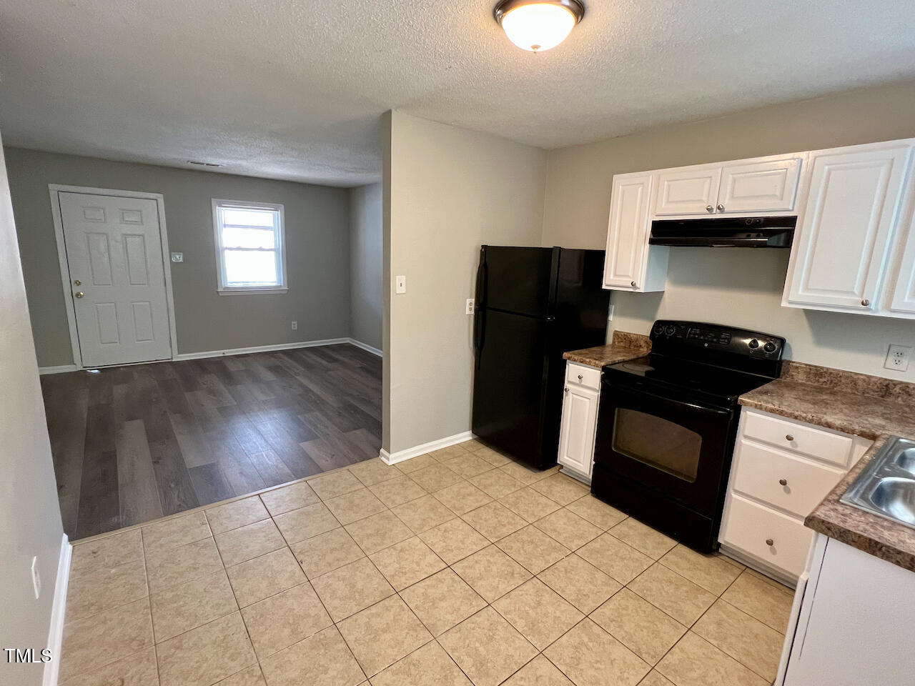 1320 Poole Road, Unit K Raleigh, NC 27610 - Photo 5 of 12 a kitchen with a refrigerator and a stove