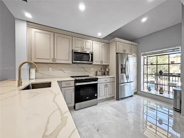a kitchen with a refrigerator stove and sink