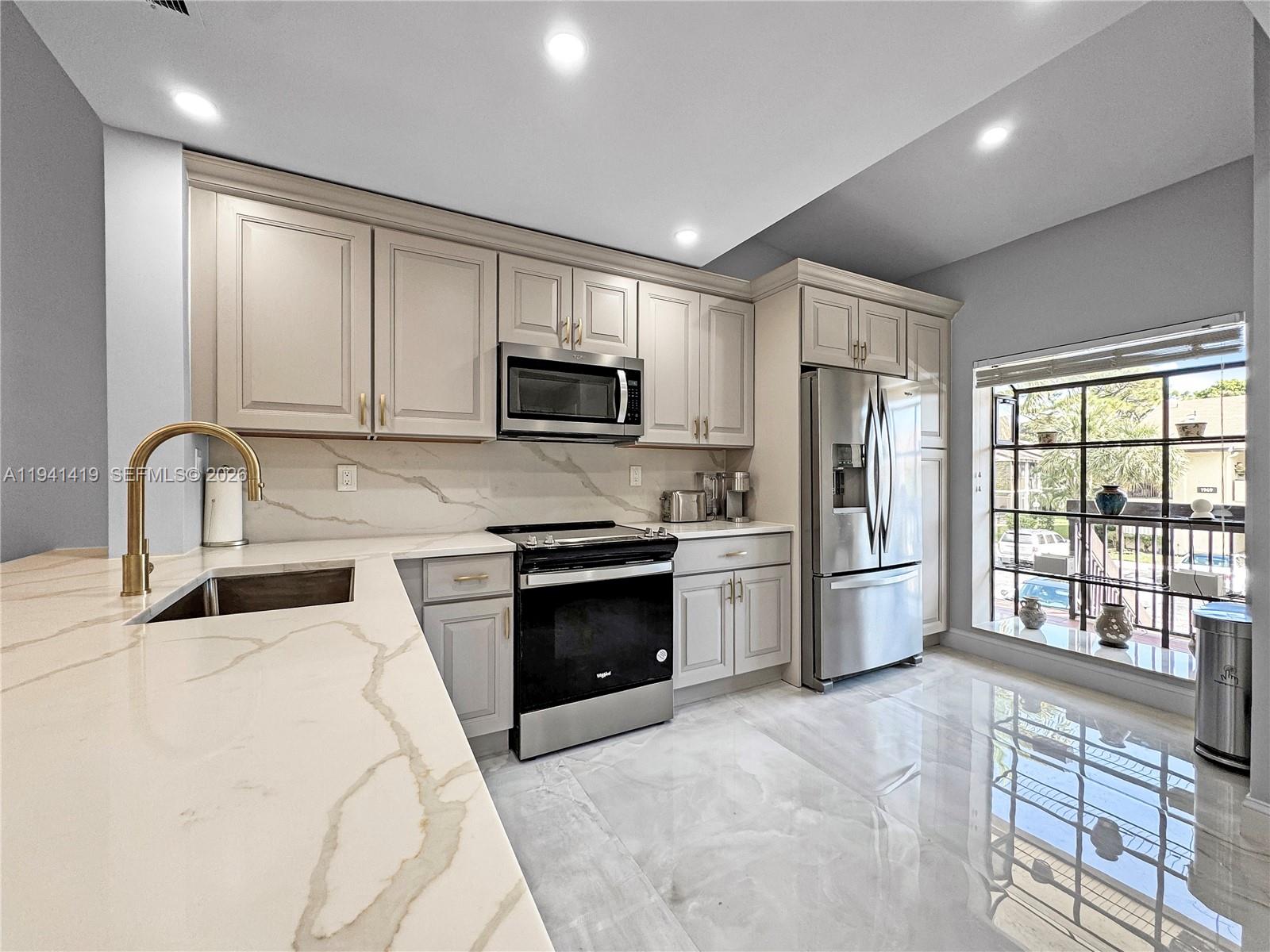 a kitchen with a refrigerator stove and sink