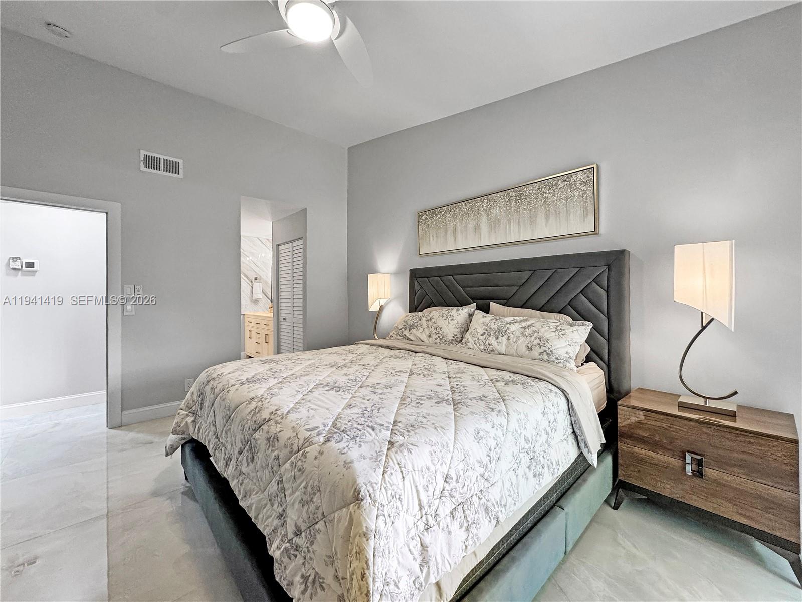 1977 Southwest 15th Street, Unit 116 Deerfield Beach, FL 33442 - Photo 11 of 37 a bedroom with a bed and dresser